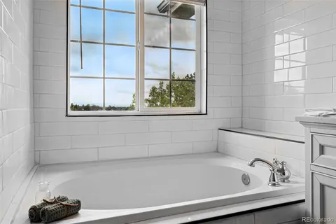 a bathroom with a bathtub and a window