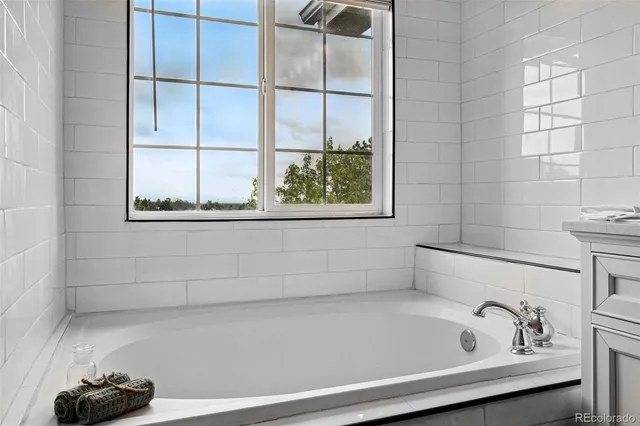a bathroom with a bathtub and a window