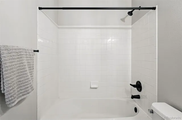 a bathroom with a shower and a bath tub