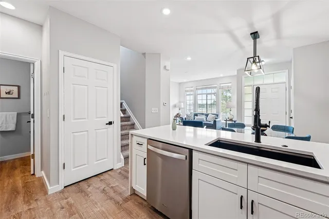 a view of a sink and cabinet with wooden floor