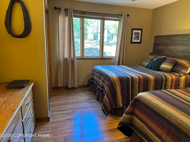 a bedroom with two beds and a window