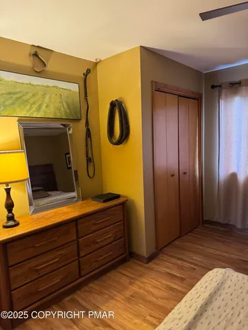a bedroom with a bed and a dresser