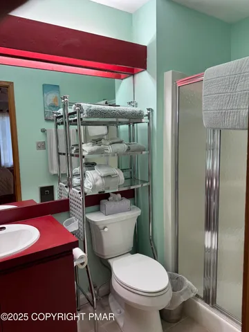a bathroom with a toilet a sink and shower