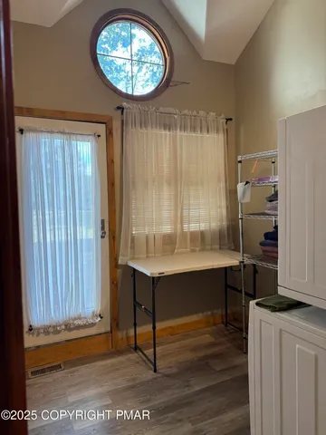 a view of room with window and wooden floor