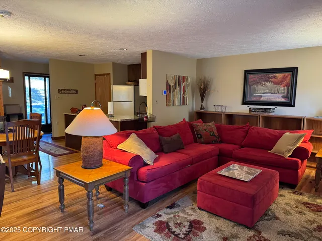 a living room with furniture a rug and a lamp