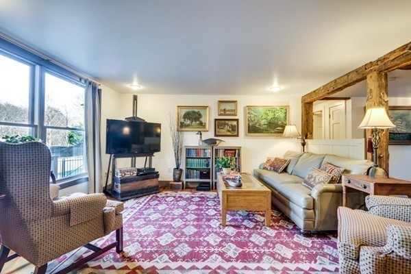 38 Larkin Road Newbury, MA 01922 - Photo 6 of 20 a living room with furniture a flat screen tv and a floor to ceiling window