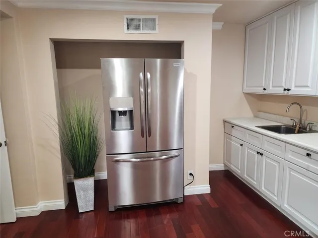 a kitchen with stainless steel appliances wooden floor and view kitchen