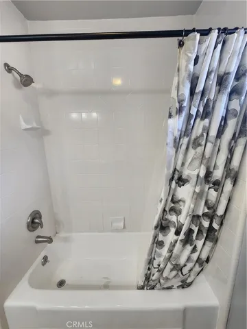 a bathroom with a bathtub and shower