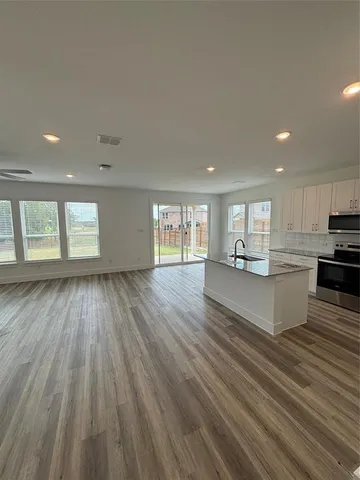 a view of kitchen and hall with wooden floor