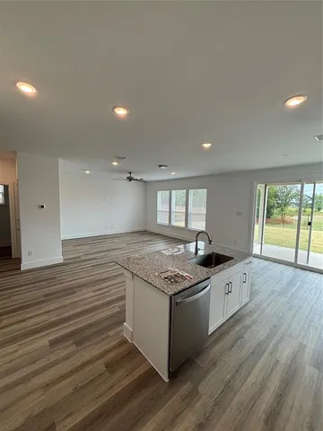 a kitchen with granite countertop a stove and a sink