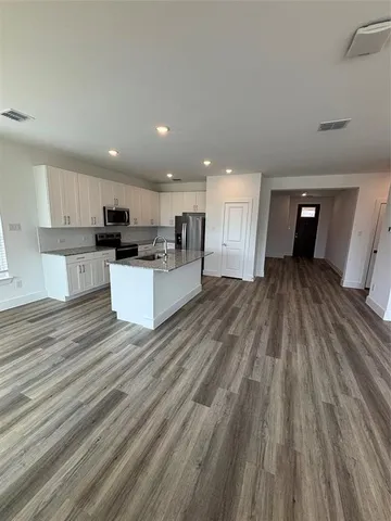 a view of kitchen and sink with wooden floor
