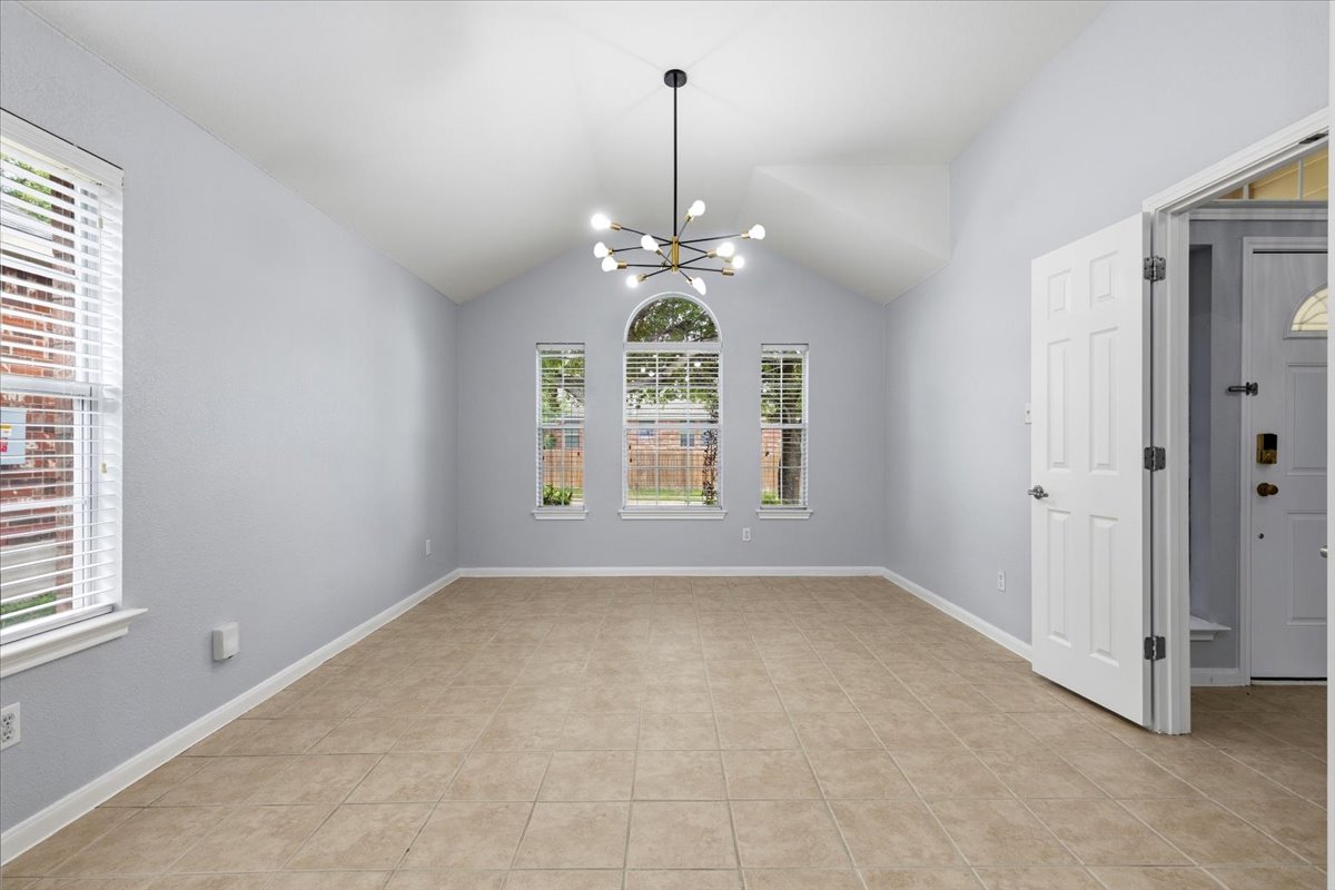 17812 Masi Loop Pflugerville, TX 78660 - Photo 8 of 38 Spacious interior featuring a vaulted ceiling and tile flooring