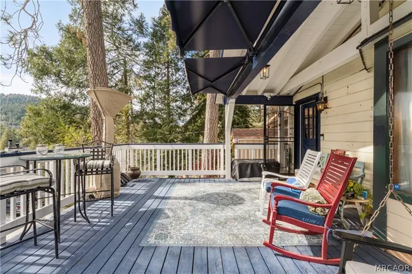 a view of balcony with wooden floor and outdoor seating