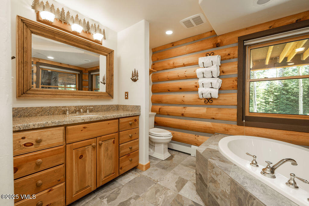 4454 Bellyache Ridge Road Wolcott, CO 81655 - Photo 19 of 48 a bathroom with a granite countertop tub sink and mirror