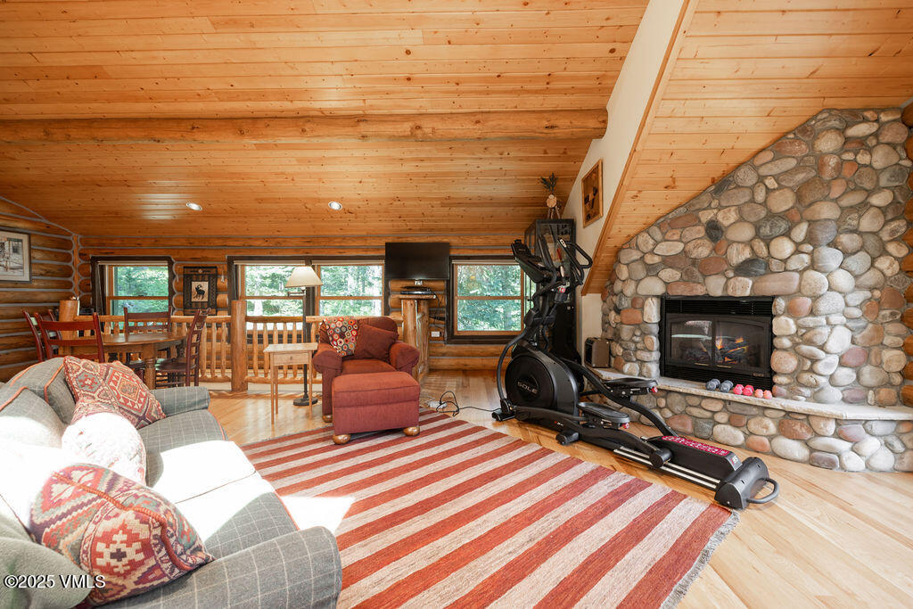 4454 Bellyache Ridge Road Wolcott, CO 81655 - Photo 21 of 48 a living room with furniture a flat screen tv and a fireplace