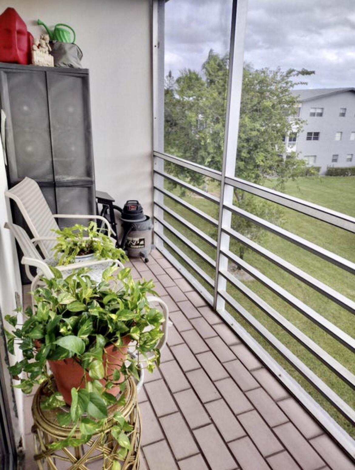 209 Suffolk F Boca Raton, FL 33434 - Photo 25 of 25 Screened Balcony w/ Garden Views