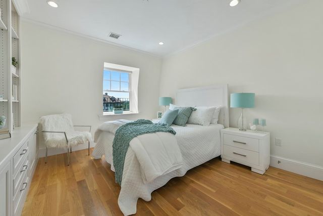 a spacious bedroom with a bed and a window