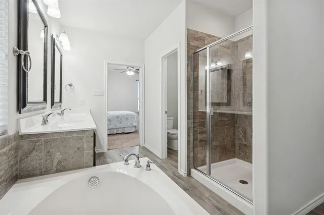 a bathroom with a tub sink and mirror
