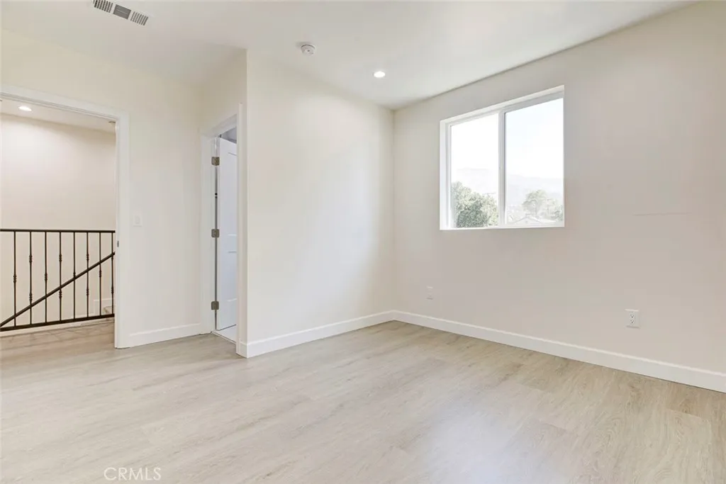 7044 Greeley Street, Unit 3 Tujunga, CA 91042 - Photo 11 of 16 an empty room with windows
