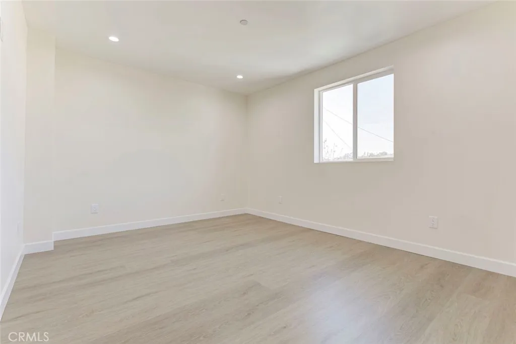 7044 Greeley Street, Unit 3 Tujunga, CA 91042 - Photo 13 of 16 an empty room with a window