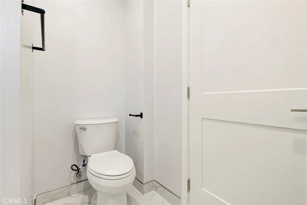 7044 Greeley Street, Unit 3 Tujunga, CA 91042 - Photo 16 of 16 a white toilet sitting next to a shower