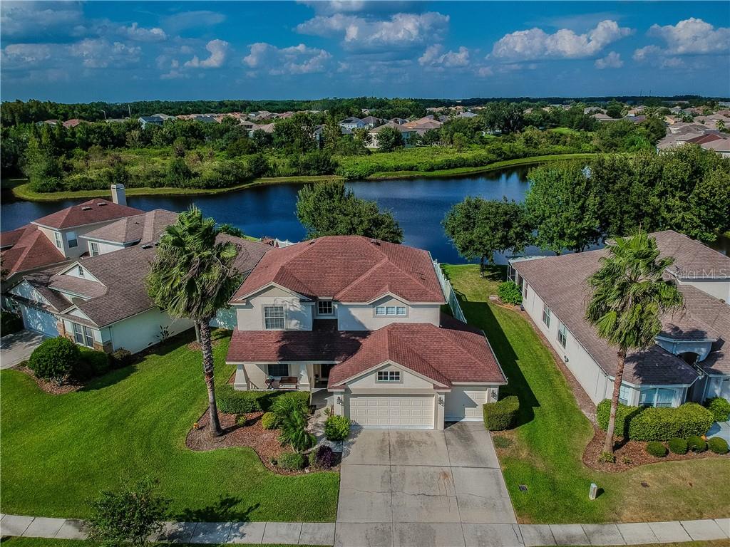 an aerial view of house with yard lake and outdoor space