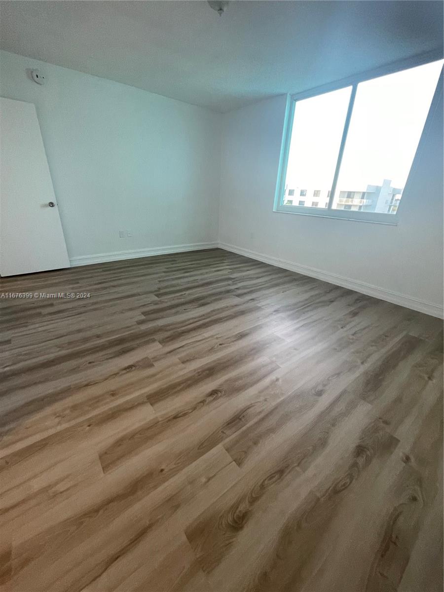 Hillcrest Hollywood, FL 33021 - Photo 12 of 37 an empty room with wooden floor and windows