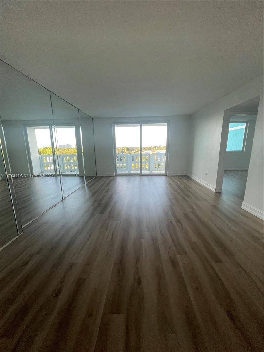 Hillcrest Hollywood, FL 33021 - Photo 5 of 37 an empty room with wooden floor and windows