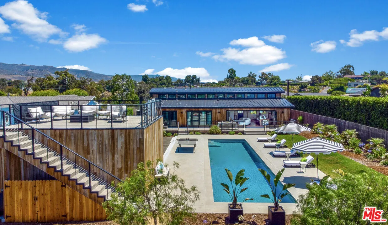 a view of a patio with couches chairs with wooden floor