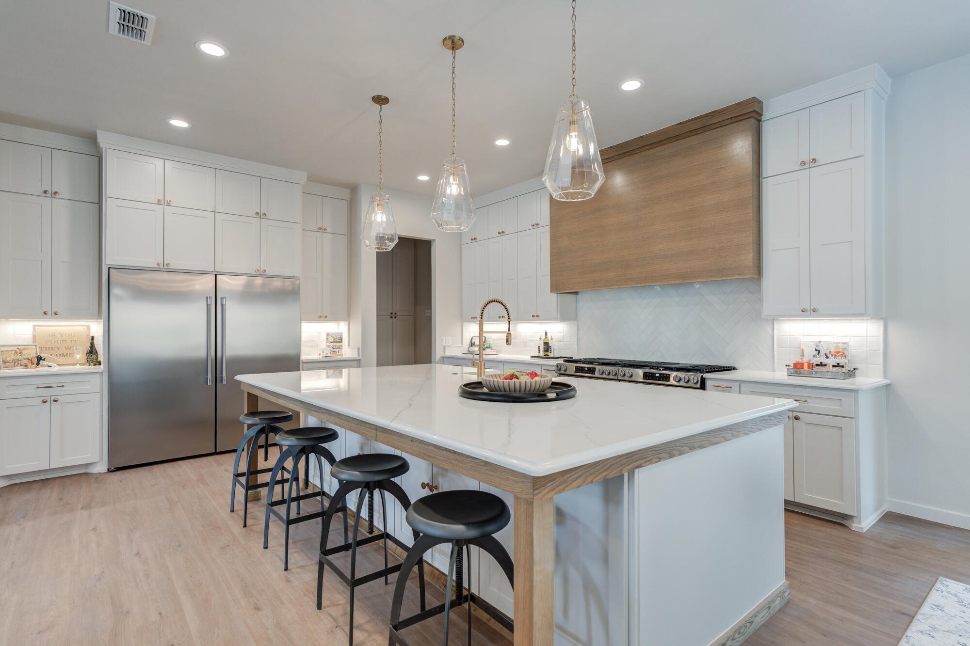 3606 126th Place Lubbock, TX 79423 - Photo 21 of 59 a kitchen with a sink a stove a refrigerator and chairs