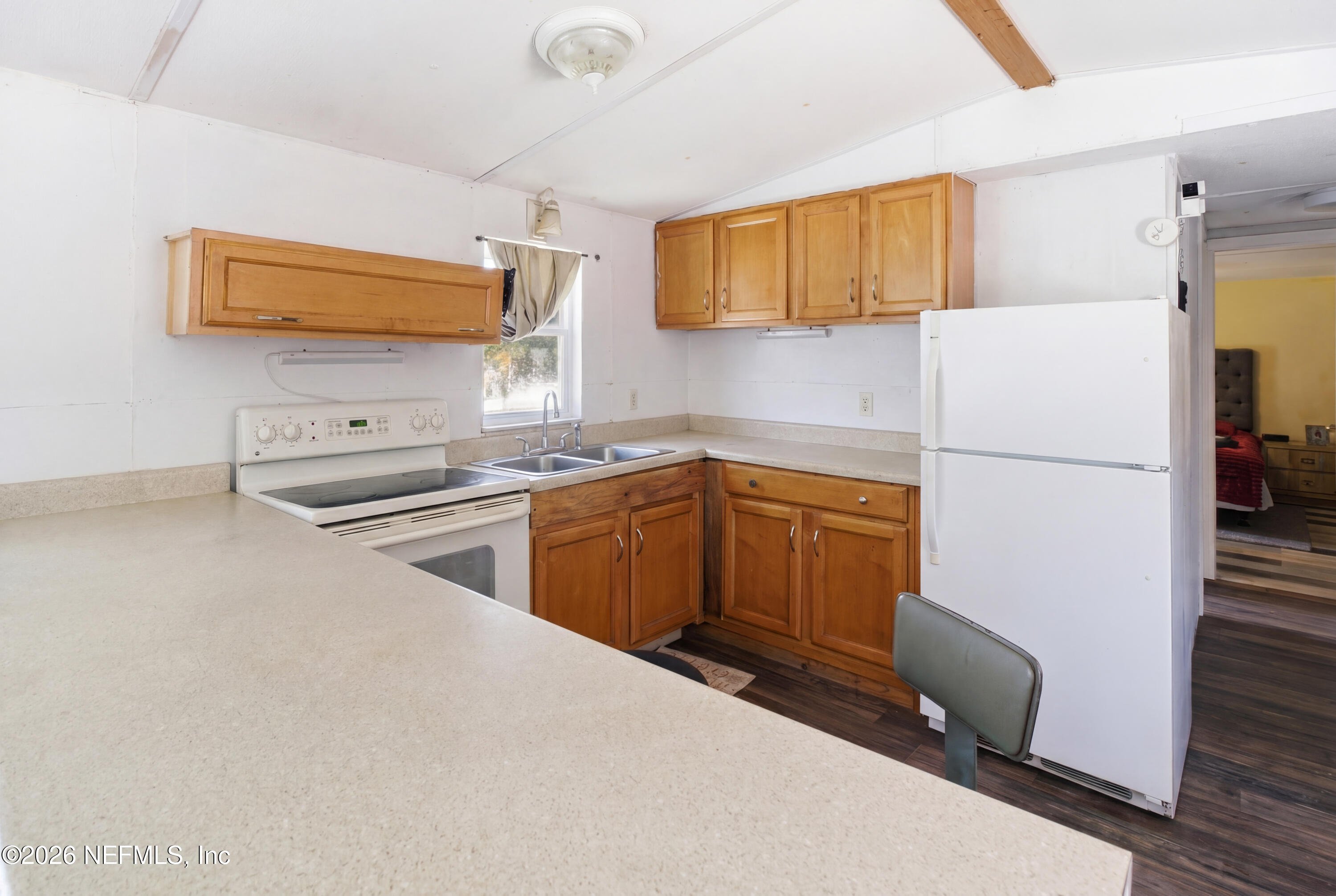 116 London Avenue Interlachen, FL 32148 - Photo 8 of 25 a kitchen with a refrigerator sink and stove