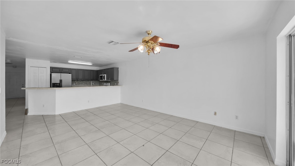 4551 22nd Street Southwest Lehigh Acres, FL 33973 - Photo 12 of 26 a view of a kitchen with microwave and cabinets