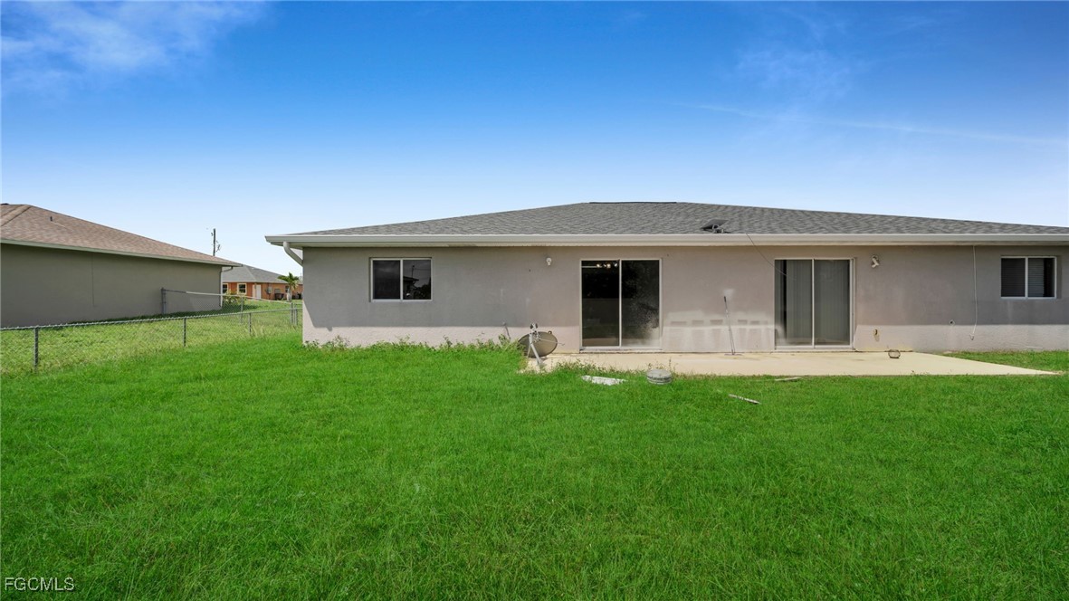 4551 22nd Street Southwest Lehigh Acres, FL 33973 - Photo 14 of 26 a front view of house with a garden