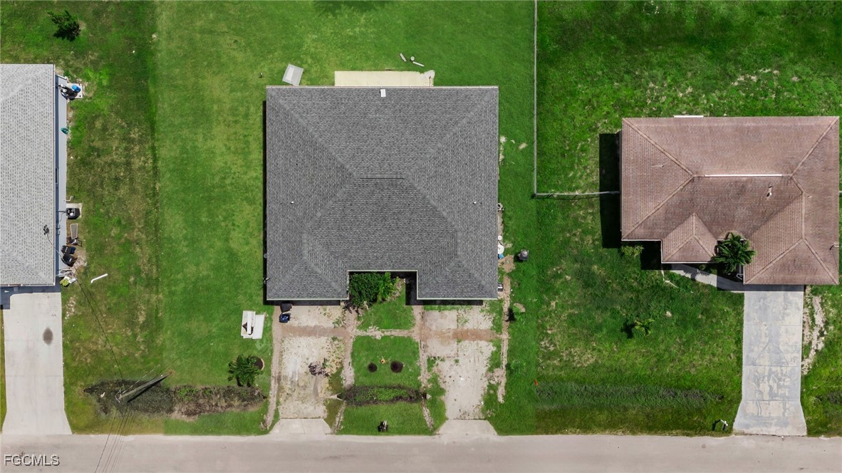 4551 22nd Street Southwest Lehigh Acres, FL 33973 - Photo 22 of 26 an aerial view of a house with a yard