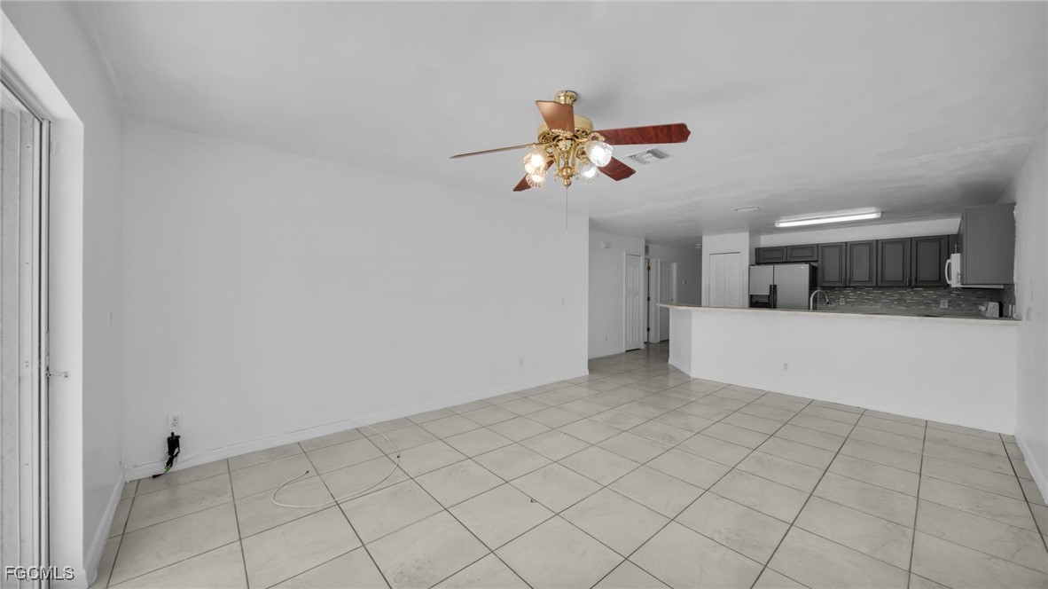 4551 22nd Street Southwest Lehigh Acres, FL 33973 - Photo 8 of 26 a view of a kitchen with a dishwasher and a microwave oven