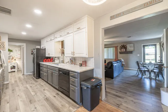 a kitchen with stainless steel appliances kitchen island granite countertop a stove and a refrigerator