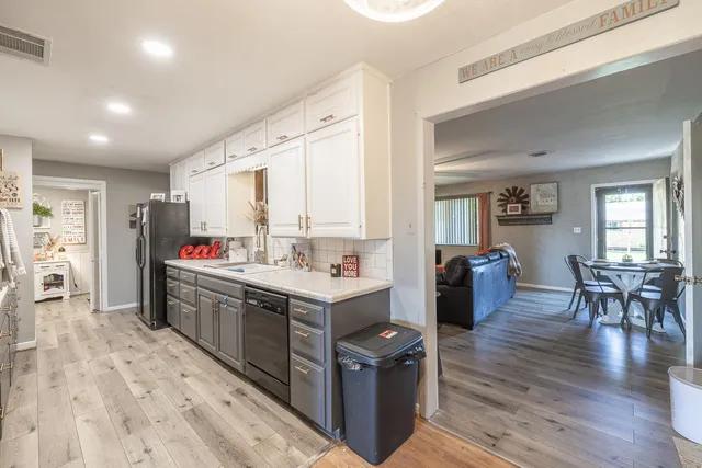 a kitchen with stainless steel appliances granite countertop a sink and wooden cabinets