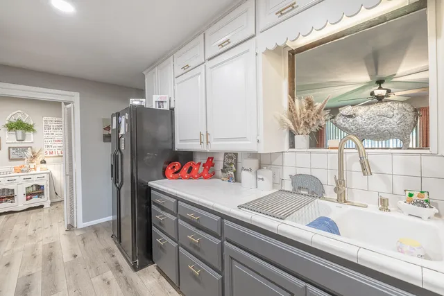 a kitchen with stainless steel appliances granite countertop a refrigerator and a stove