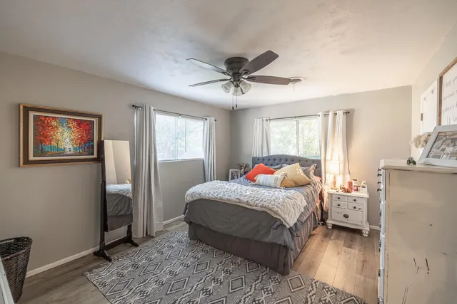 a bedroom with a bed and wooden floor