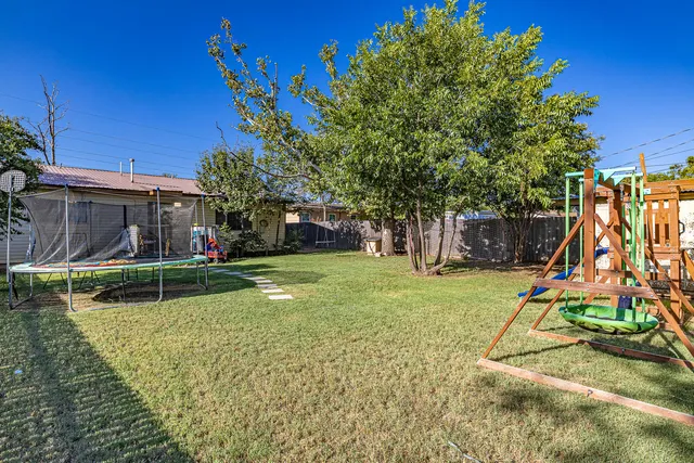 a view of a house with swimming pool and a yard