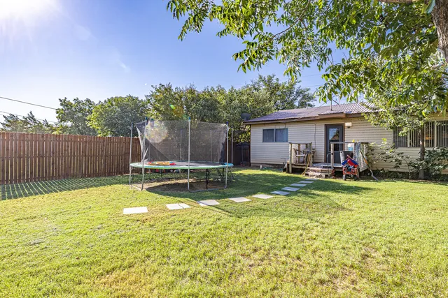 a view of a house with swimming pool and sitting area