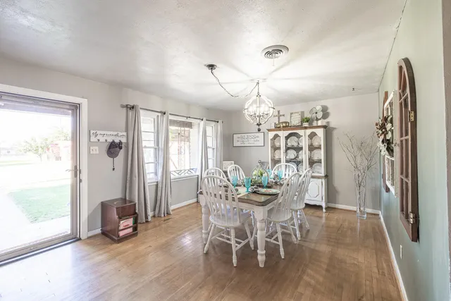 a view of a dining room with furniture and wooden floor