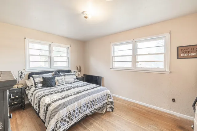 a bedroom with a bed and a window