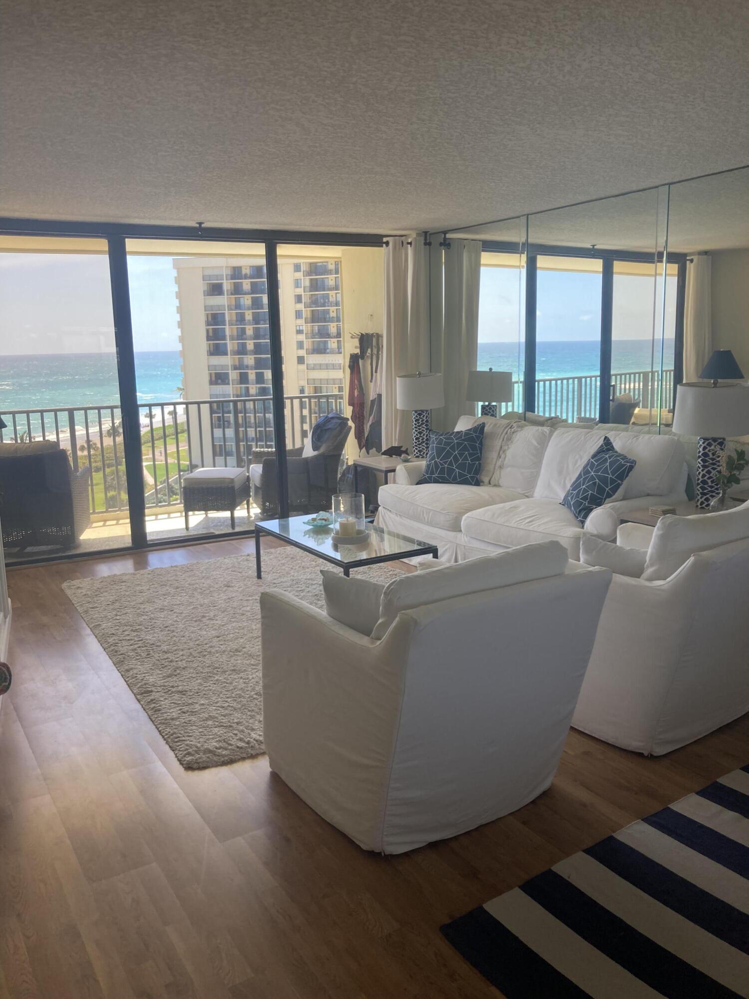 400 Ocean Trail Way, Unit 904 Jupiter, FL 33477 - Photo 2 of 31 a living room with furniture and a floor to ceiling window