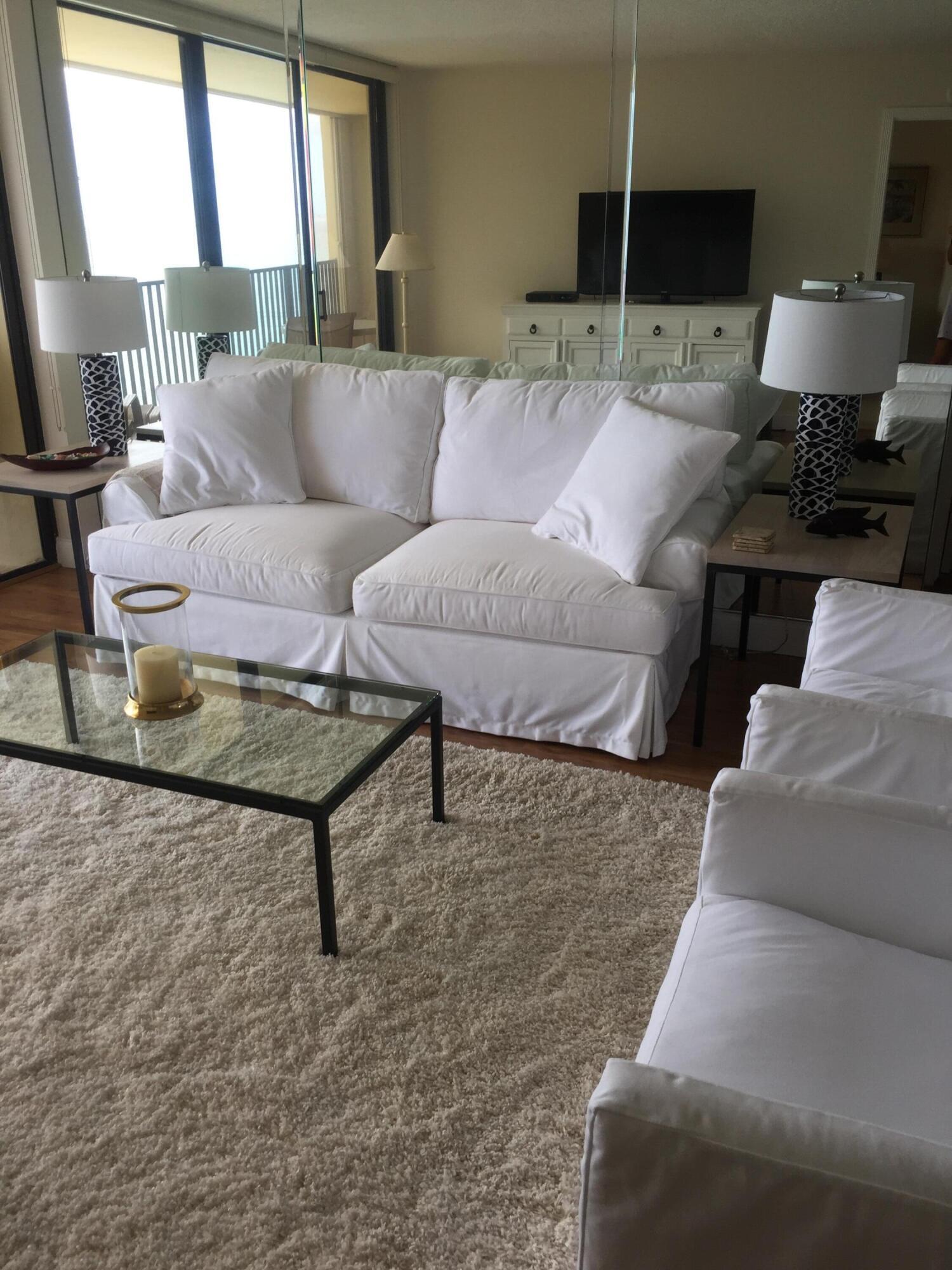 400 Ocean Trail Way, Unit 904 Jupiter, FL 33477 - Photo 27 of 31 a living room with furniture and a flat screen tv