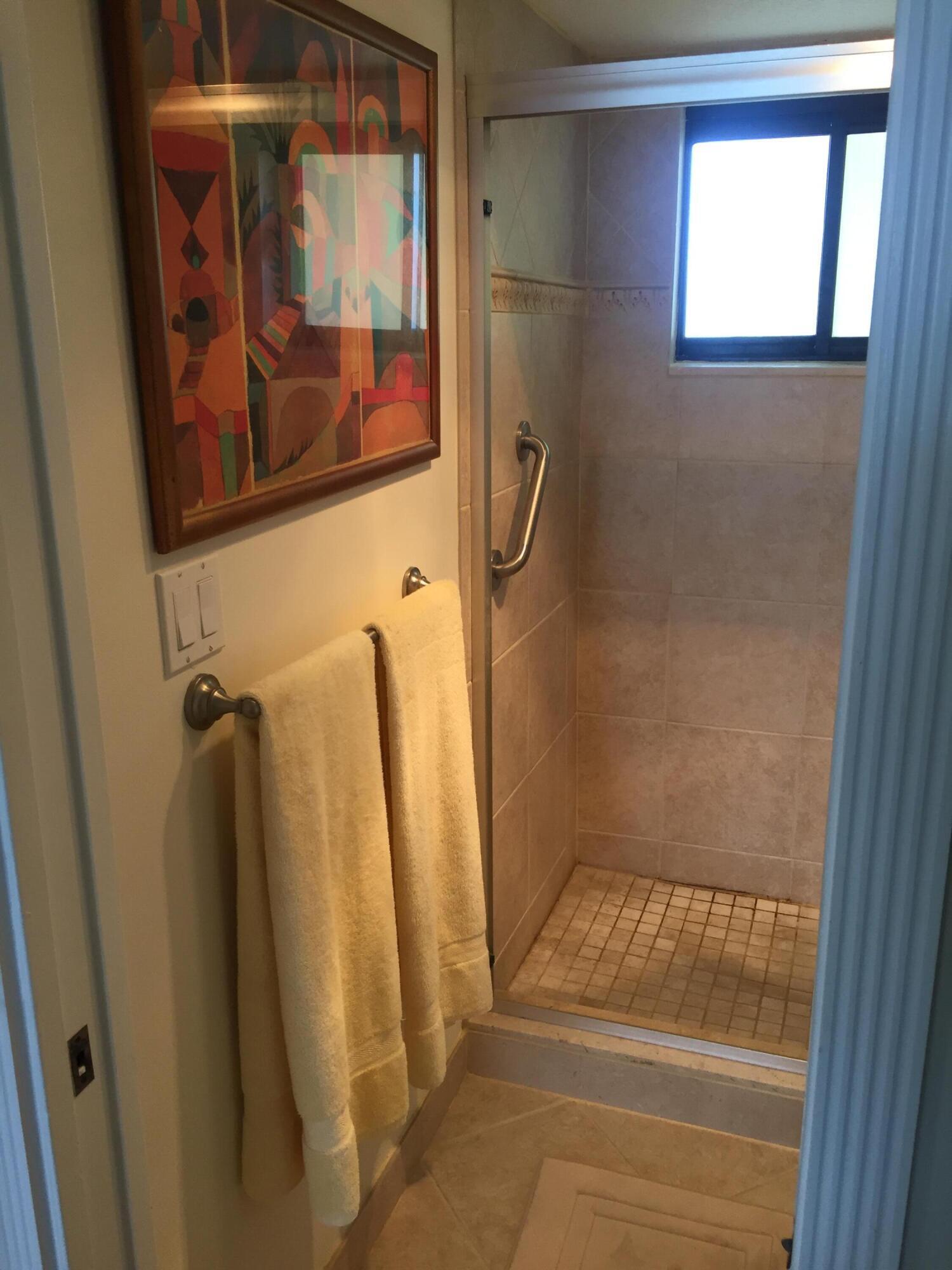 400 Ocean Trail Way, Unit 904 Jupiter, FL 33477 - Photo 28 of 31 a bathroom with a shower