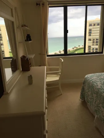 a room with a bed and a large window