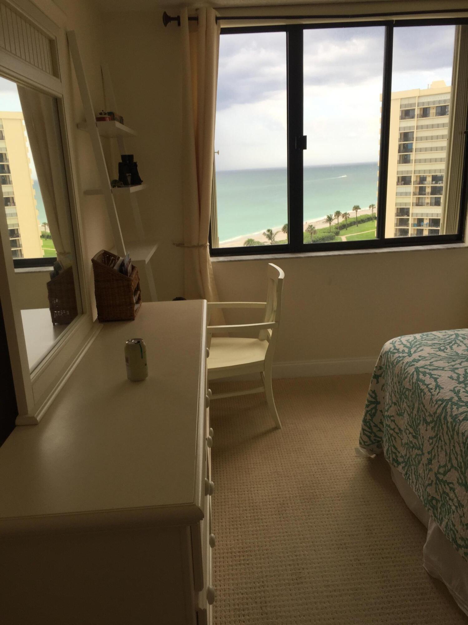 400 Ocean Trail Way, Unit 904 Jupiter, FL 33477 - Photo 31 of 31 a room with a bed and a large window