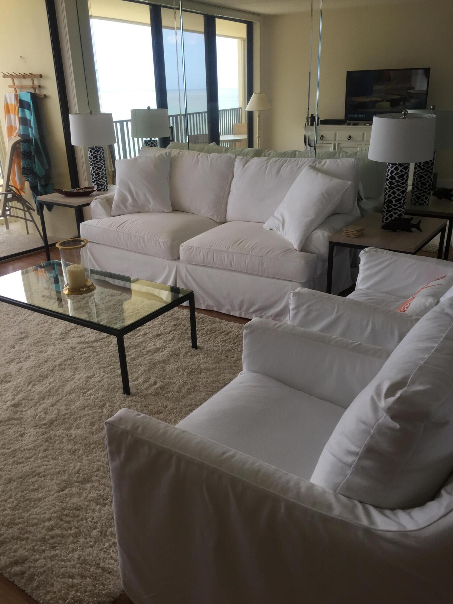 400 Ocean Trail Way, Unit 904 Jupiter, FL 33477 - Photo 9 of 31 a living room with furniture and a flat screen tv