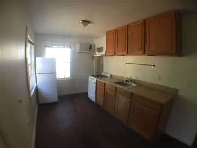 a kitchen with sink cabinets and stainless steel appliances